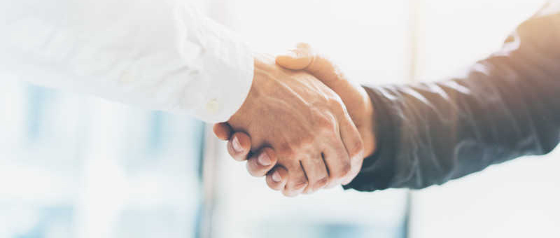 Business partnership meeting. Picture businessmans handshake. Successful businessmen handshaking after good deal. Horizontal, blurred